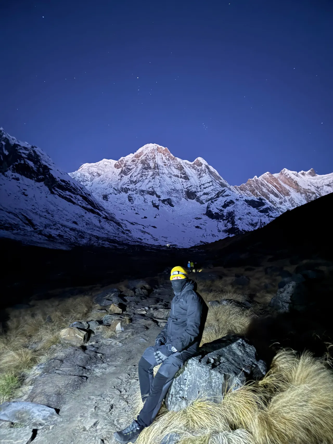 Everest Base Camp — climbing a rock face under a starlit summit